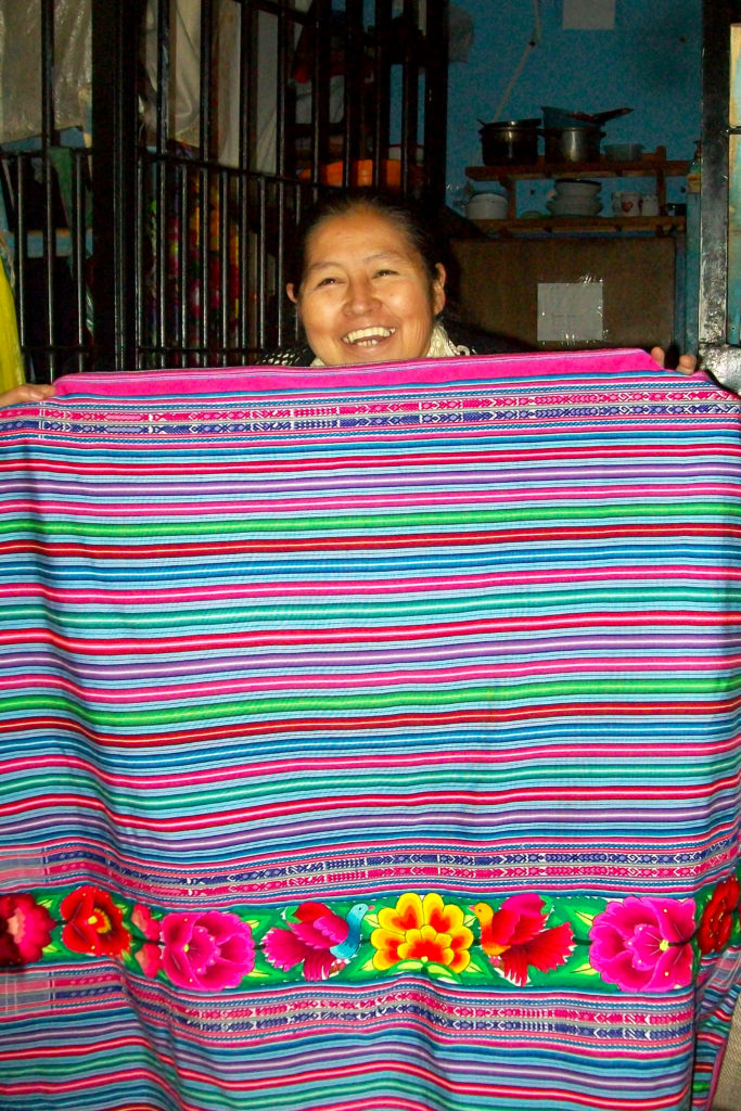 Showing off a beautiful manta she embroidered 